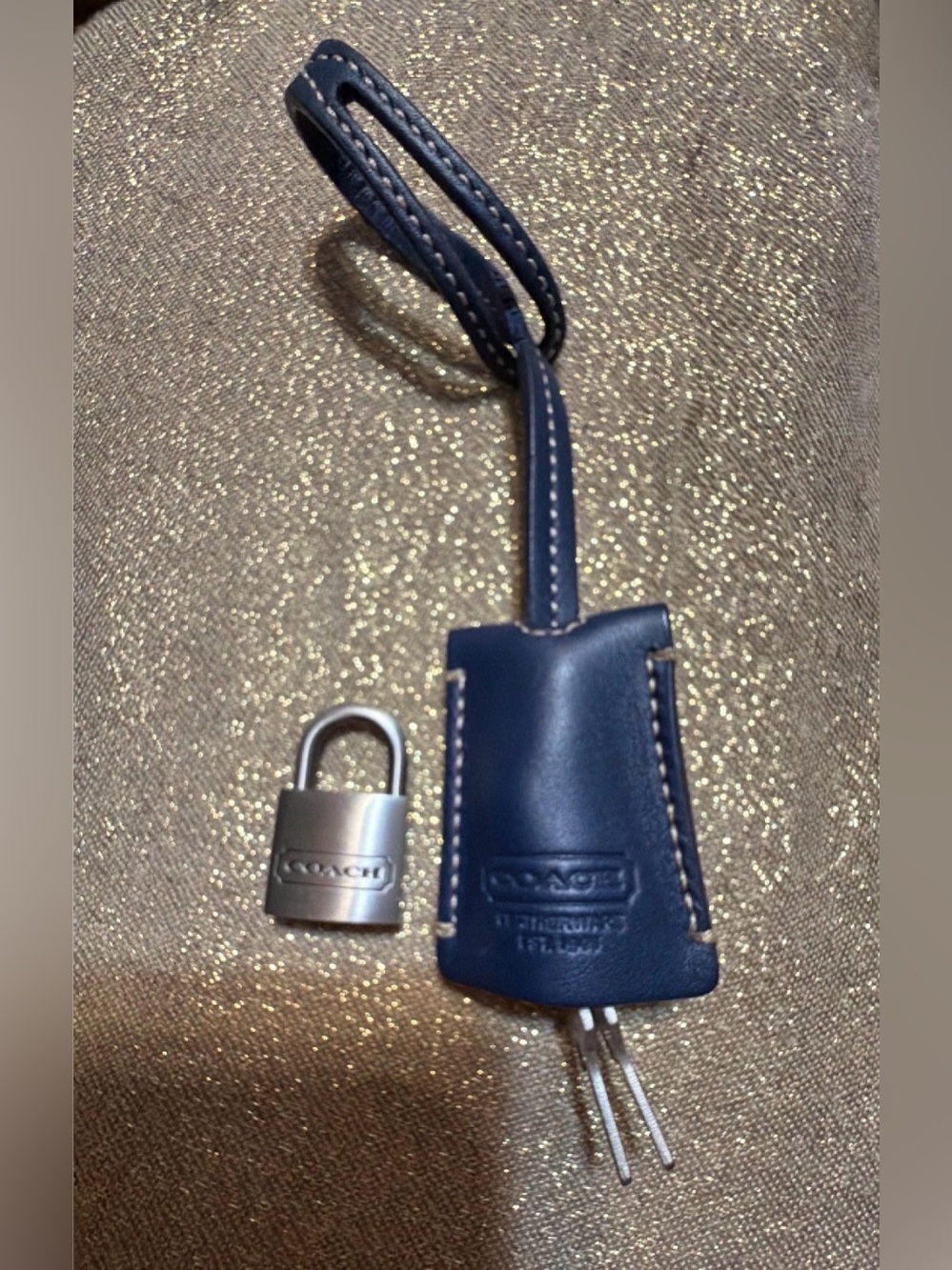 Coach leather clochette bag charm with a coordinating padlock and key set